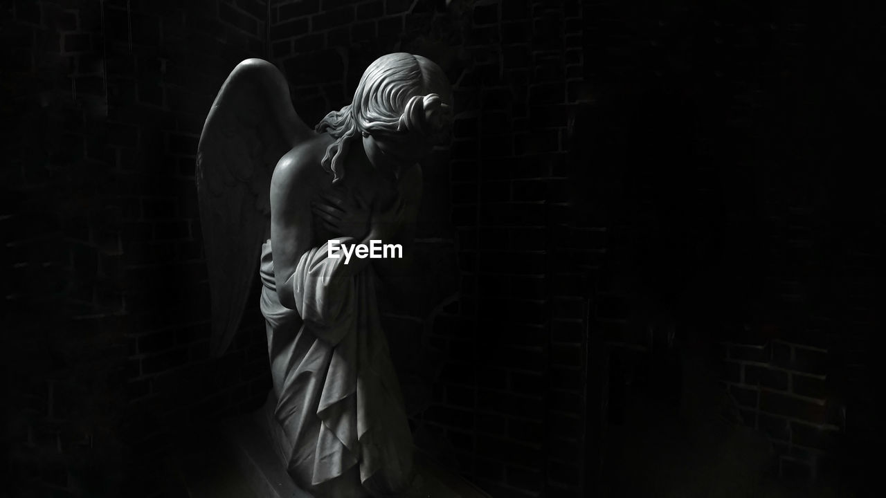 View of angel statue in darkroom