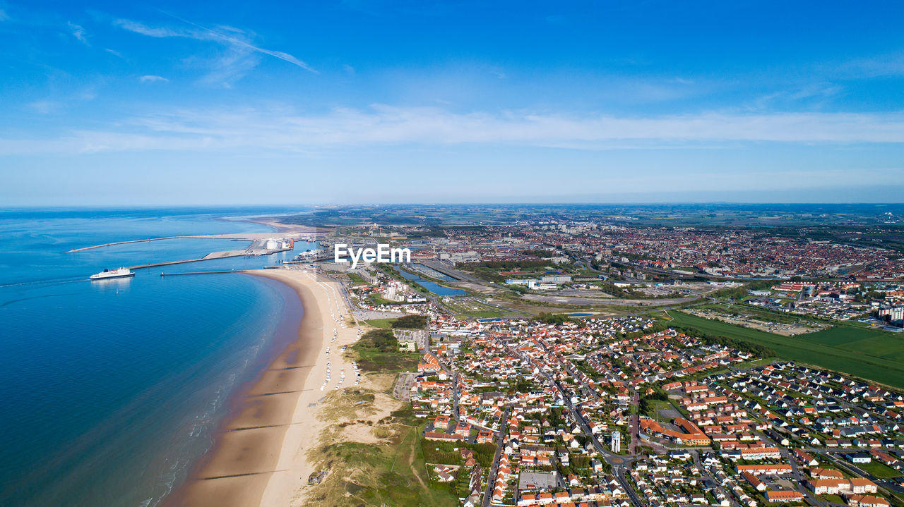 High angle view of bay and cityscape against sky