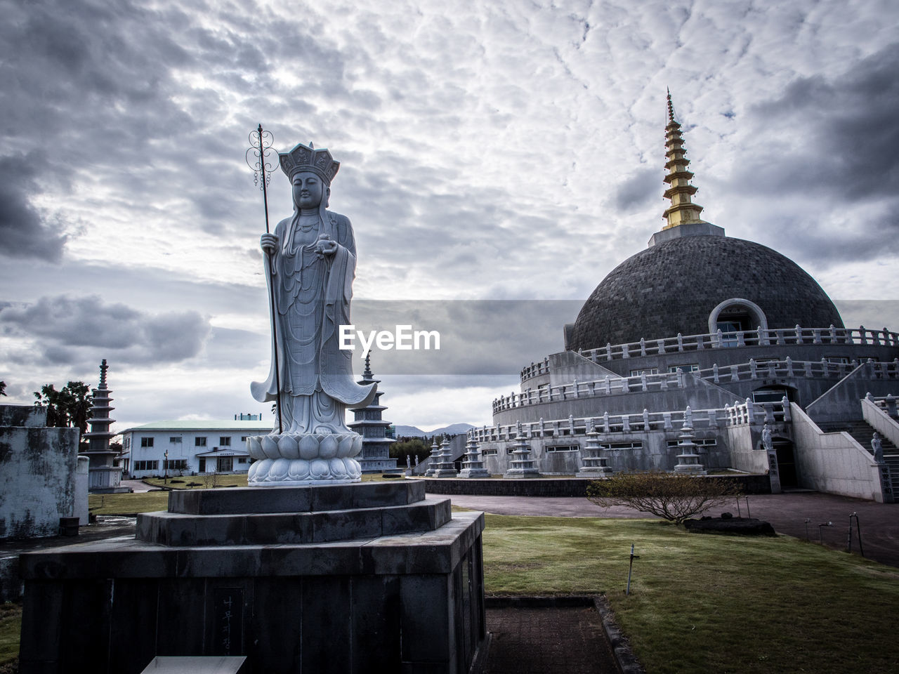 TEMPLE AGAINST CLOUDY SKY