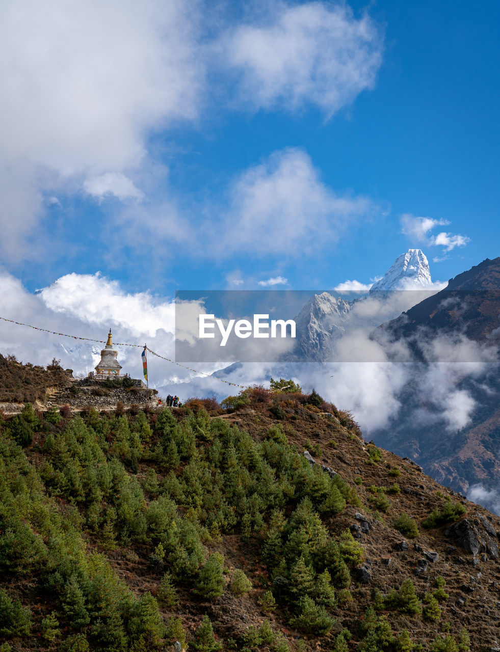 Panoramic view of green landscape with mountains against sky