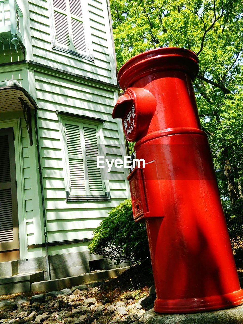 VIEW OF BUILDING WITH RED FLOWERS