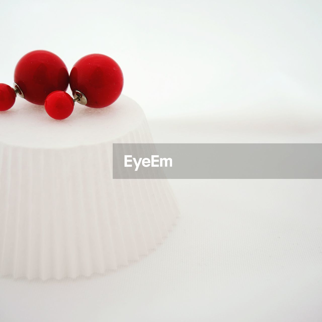 CLOSE-UP OF CHERRIES ON WHITE BACKGROUND