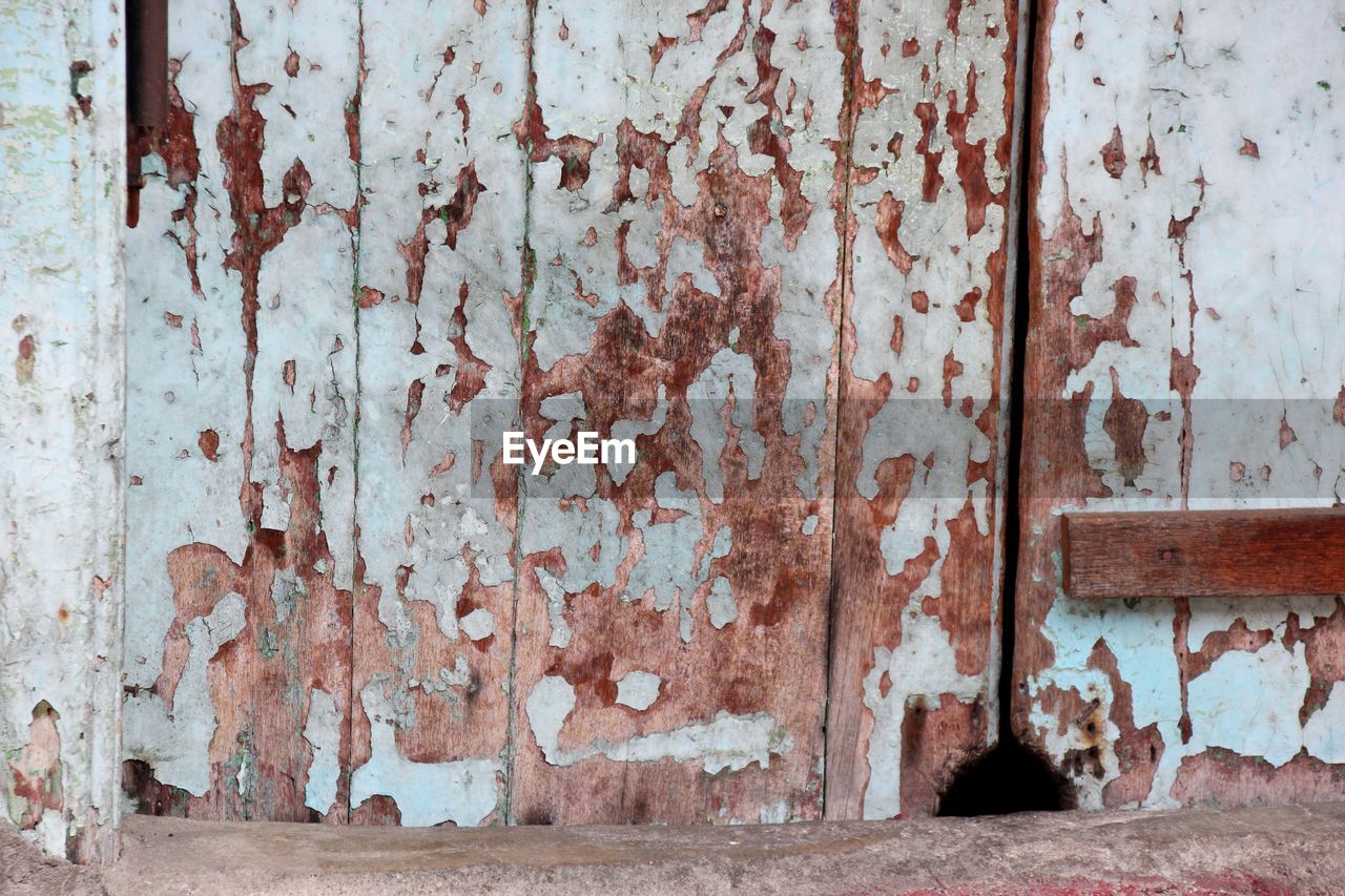 Closed wooden door of abandoned house