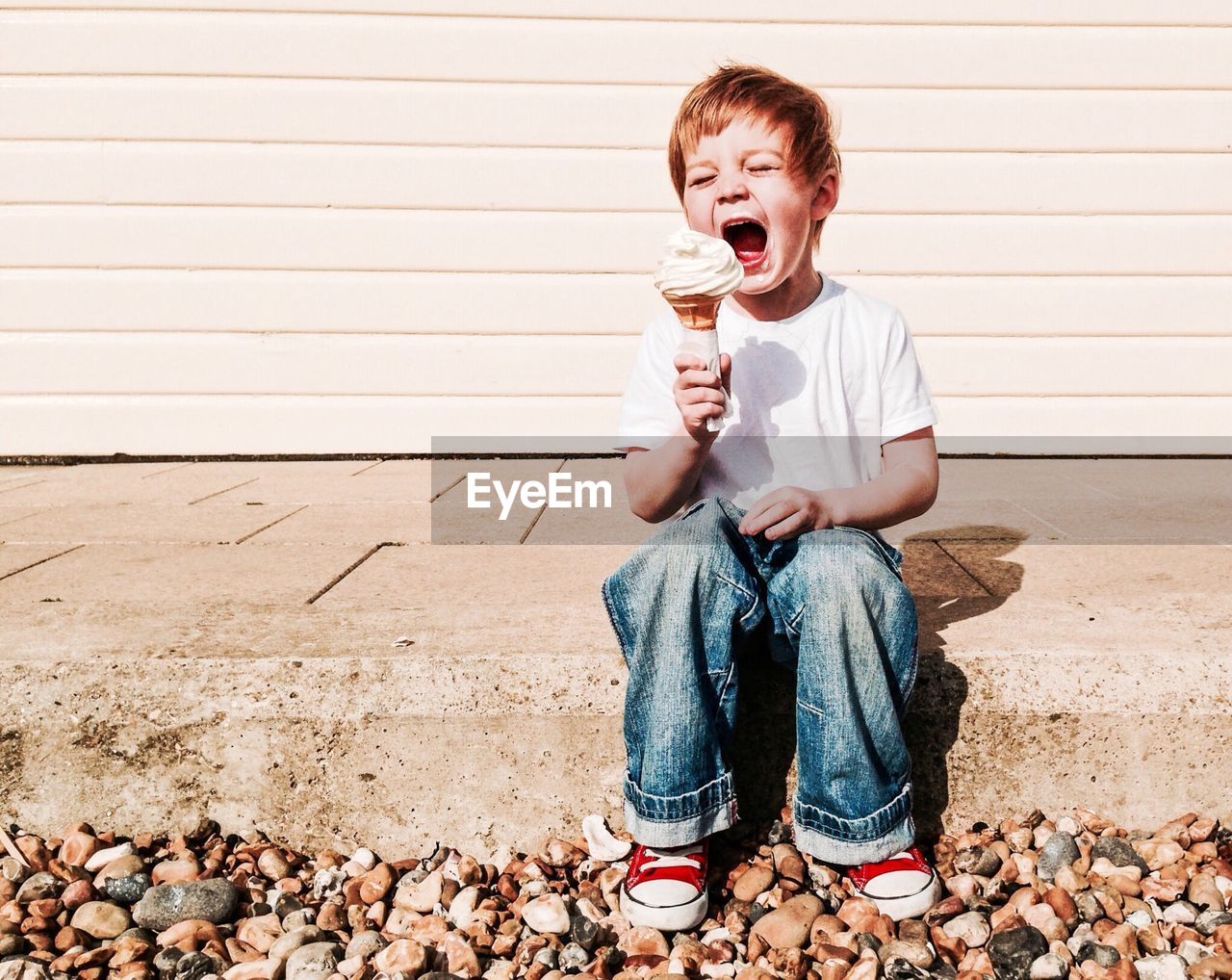 Boy eating ice cream outdoors