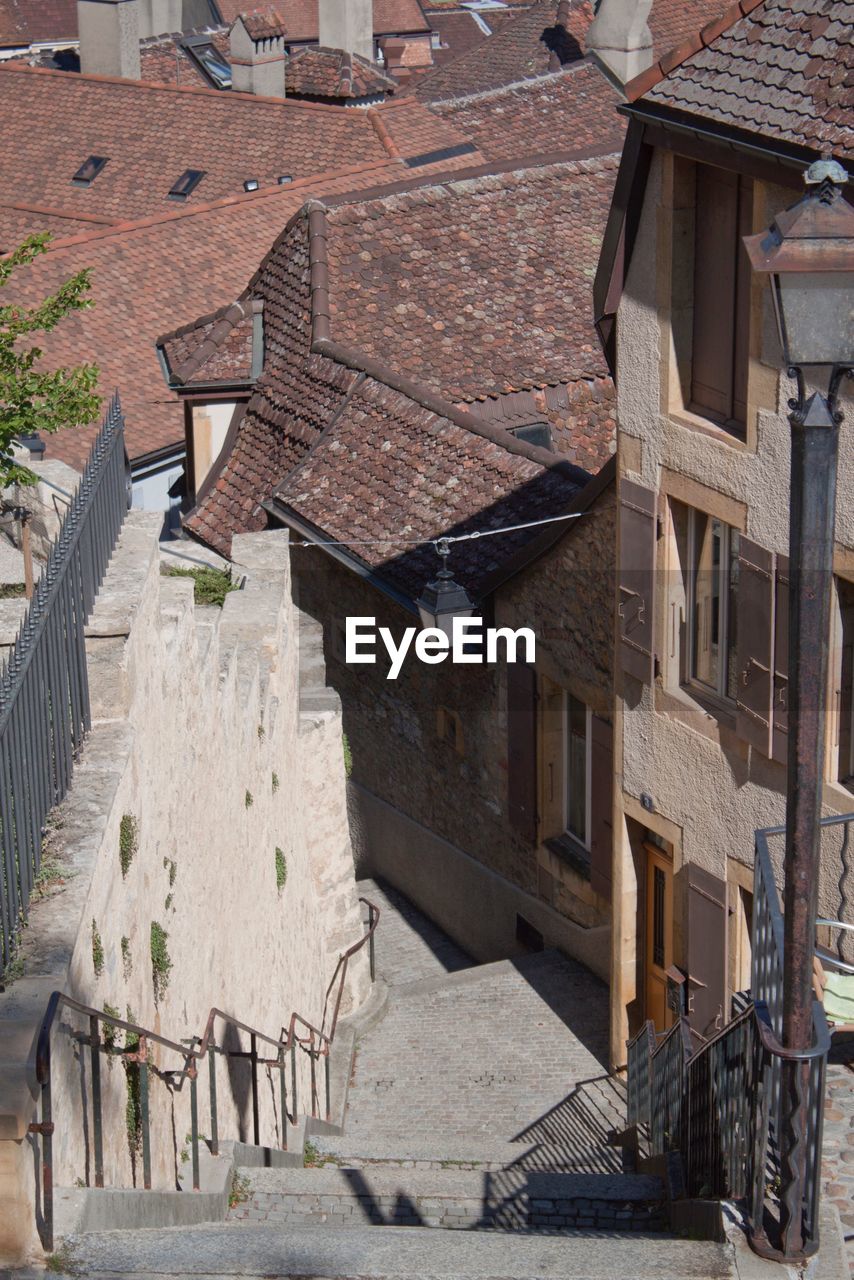 High angle view of houses by street in city