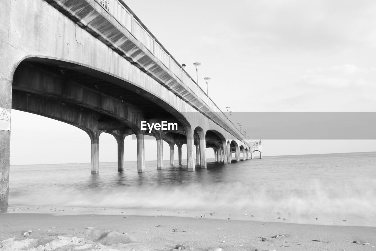 Bridge over sea against sky