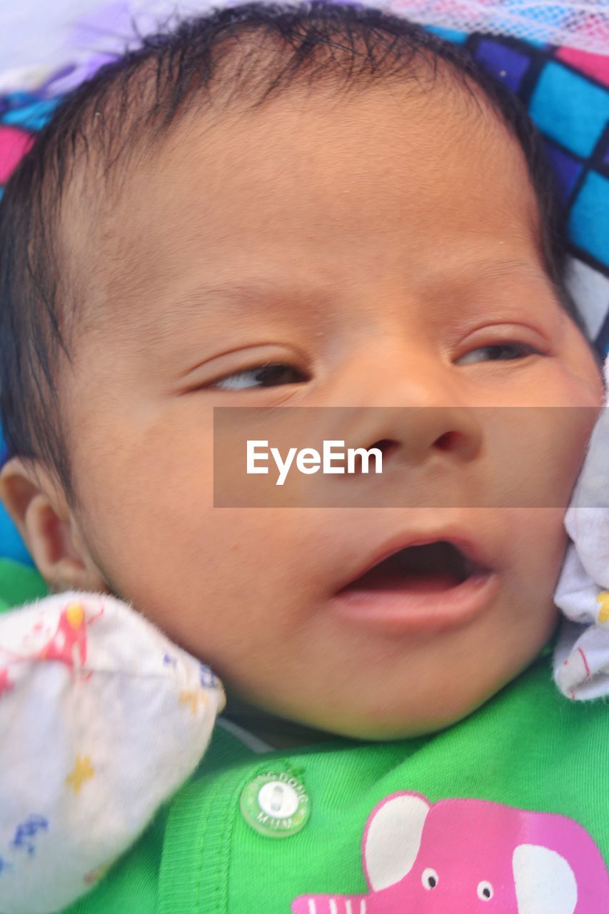 CLOSE-UP PORTRAIT OF CUTE BABY LYING