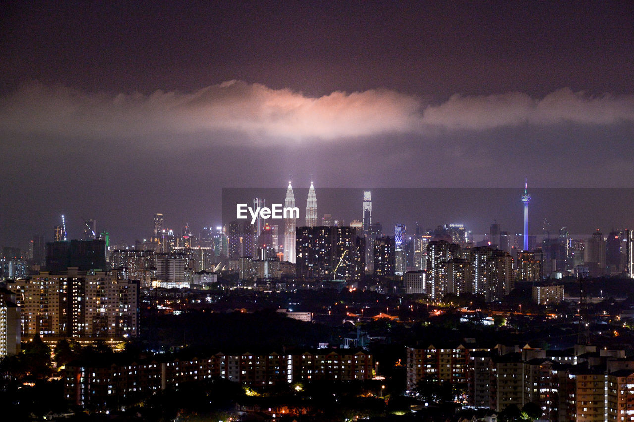 PANORAMIC VIEW OF ILLUMINATED BUILDINGS AGAINST SKY