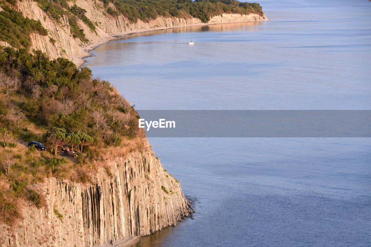 HIGH ANGLE VIEW OF SEA BY CLIFF