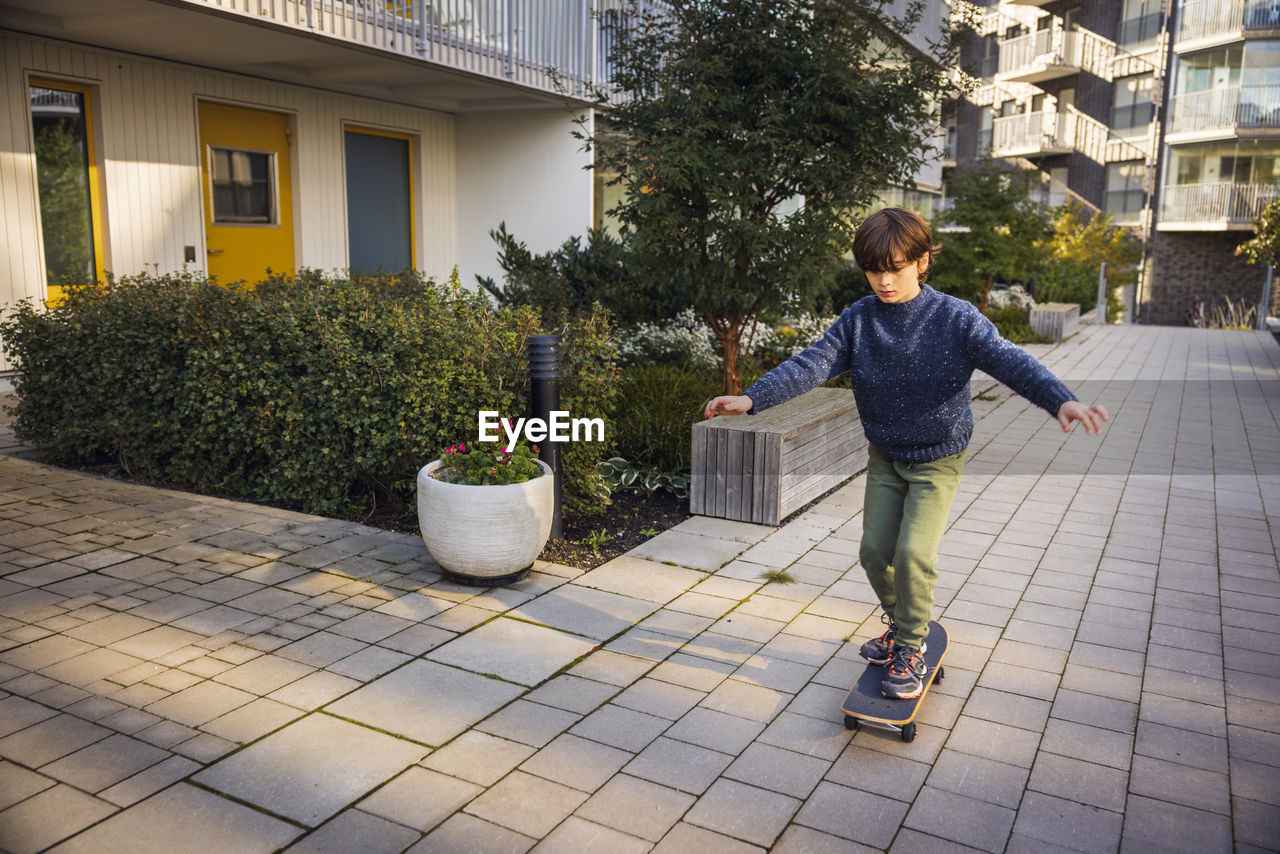 Boy skateboarding in residential area