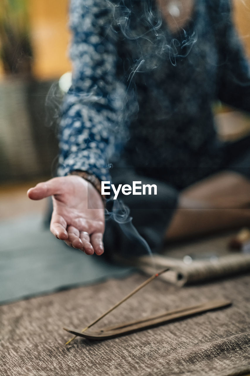 Woman meditating while exercising at home