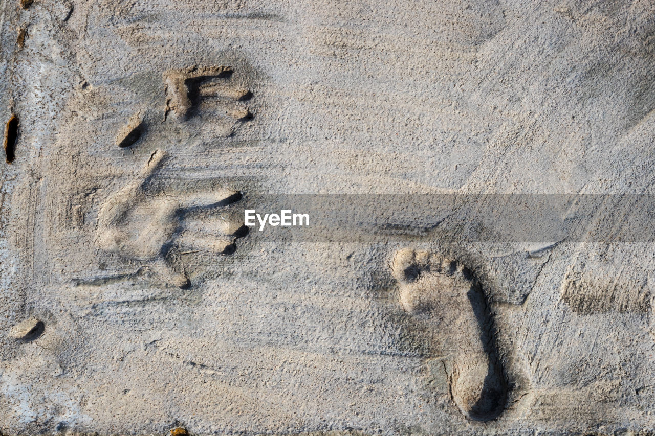 FULL FRAME SHOT OF FOOTPRINTS ON SAND AT BEACH