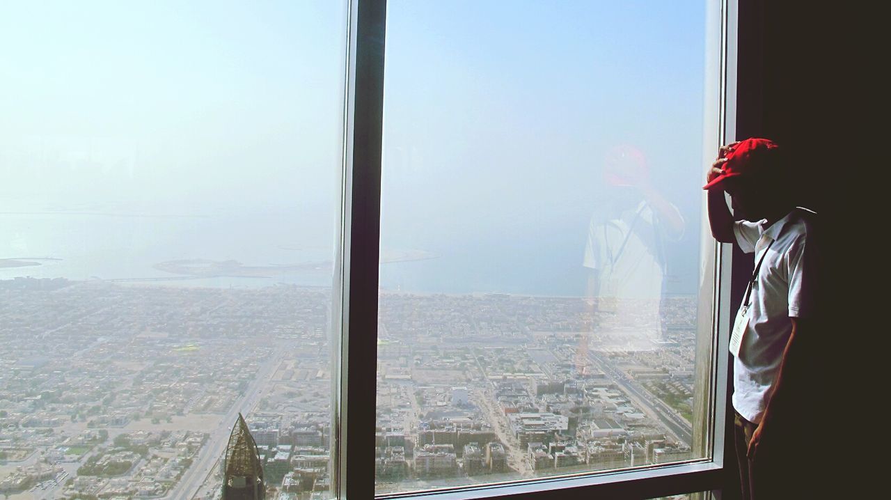 Man standing by glass window