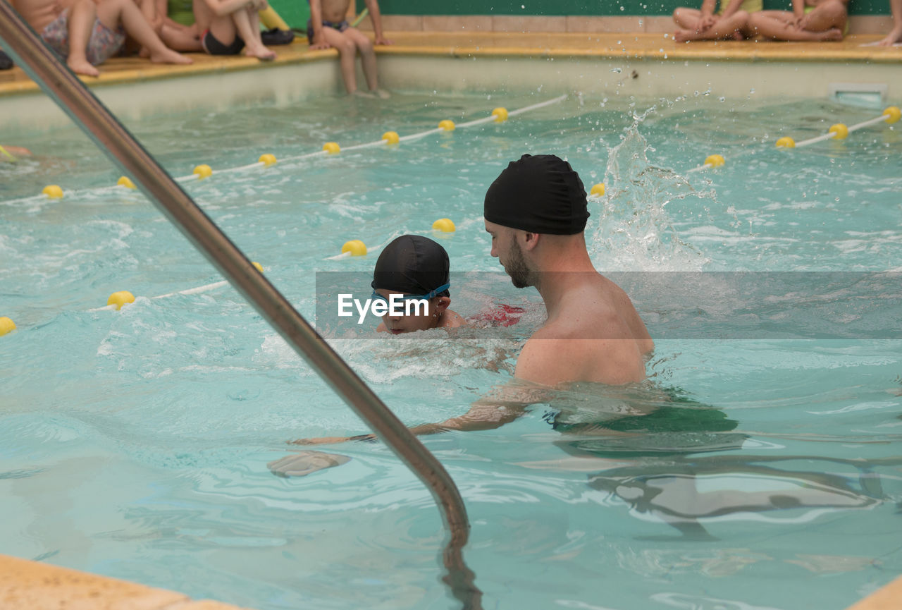 Teacher and student learning to swim