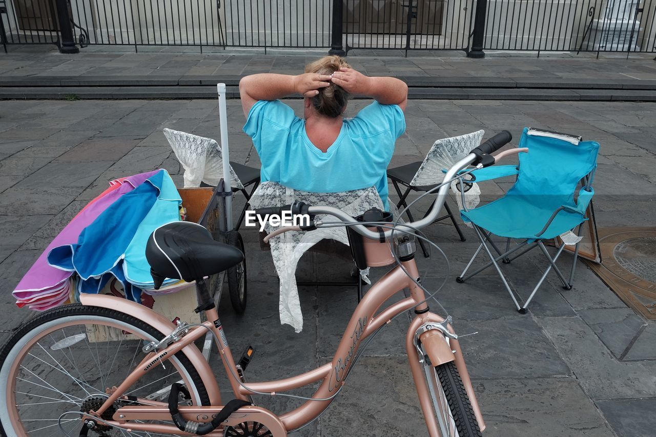 WOMAN SITTING ON CHAIR