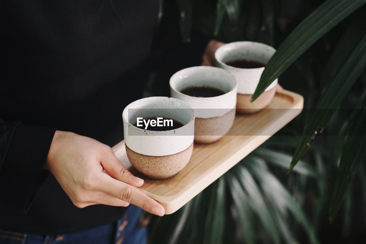 Cropped image of hand holding coffee cup