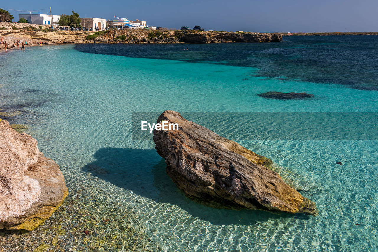High angle view of rocks on beach against sky in favignana