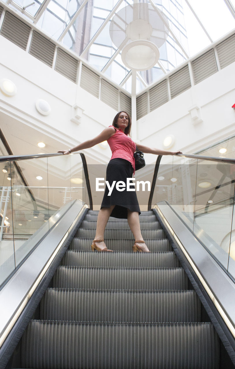 WOMAN STANDING BY RAILING