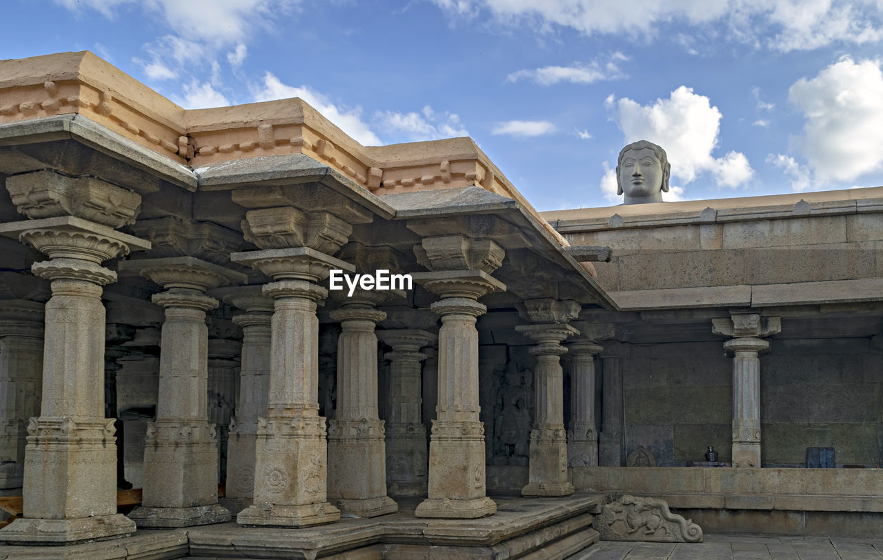 Stone carved temple and statue of lord bahubali in shravanbela gola, karnataka.