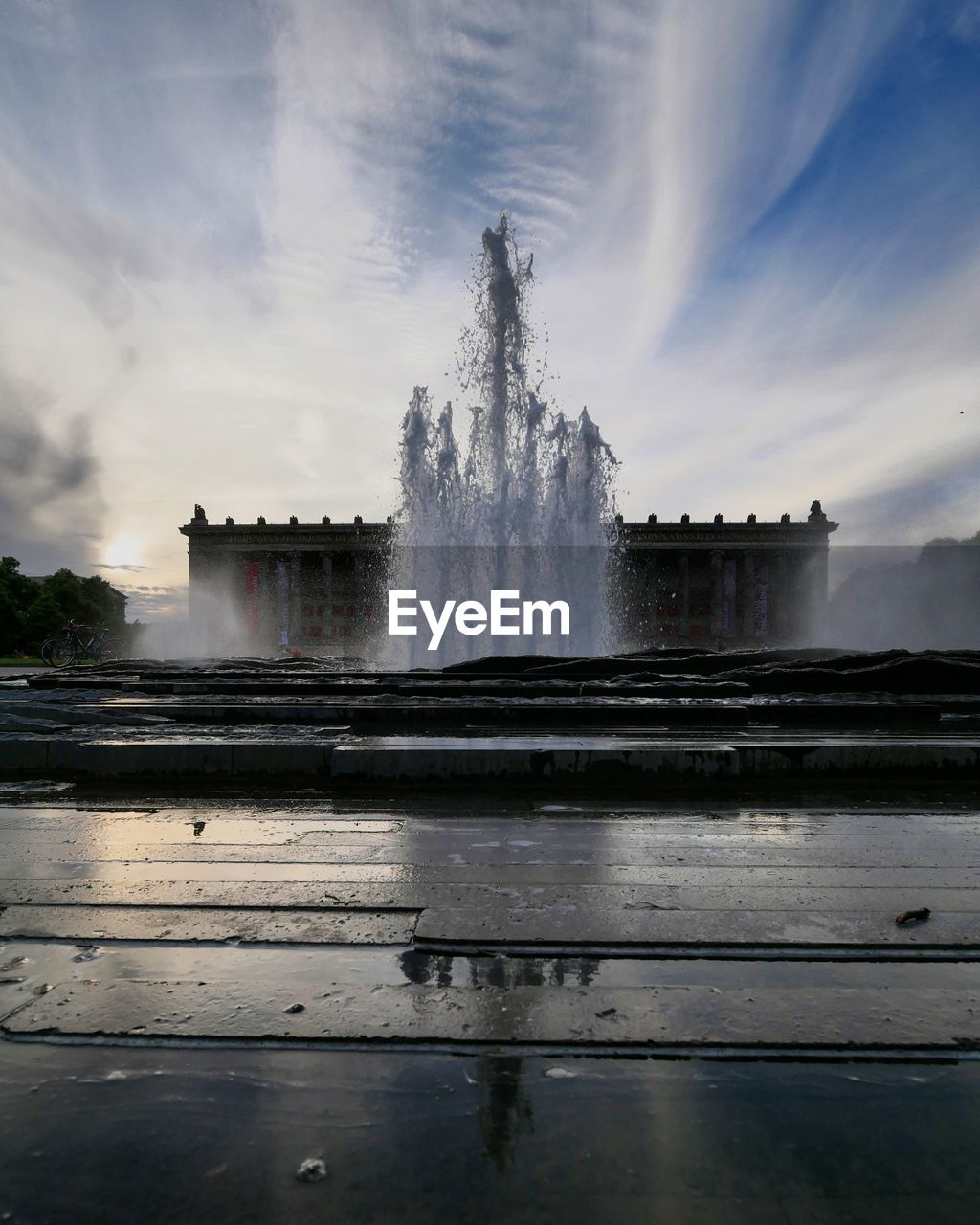 Fountain against altes museum during sunset