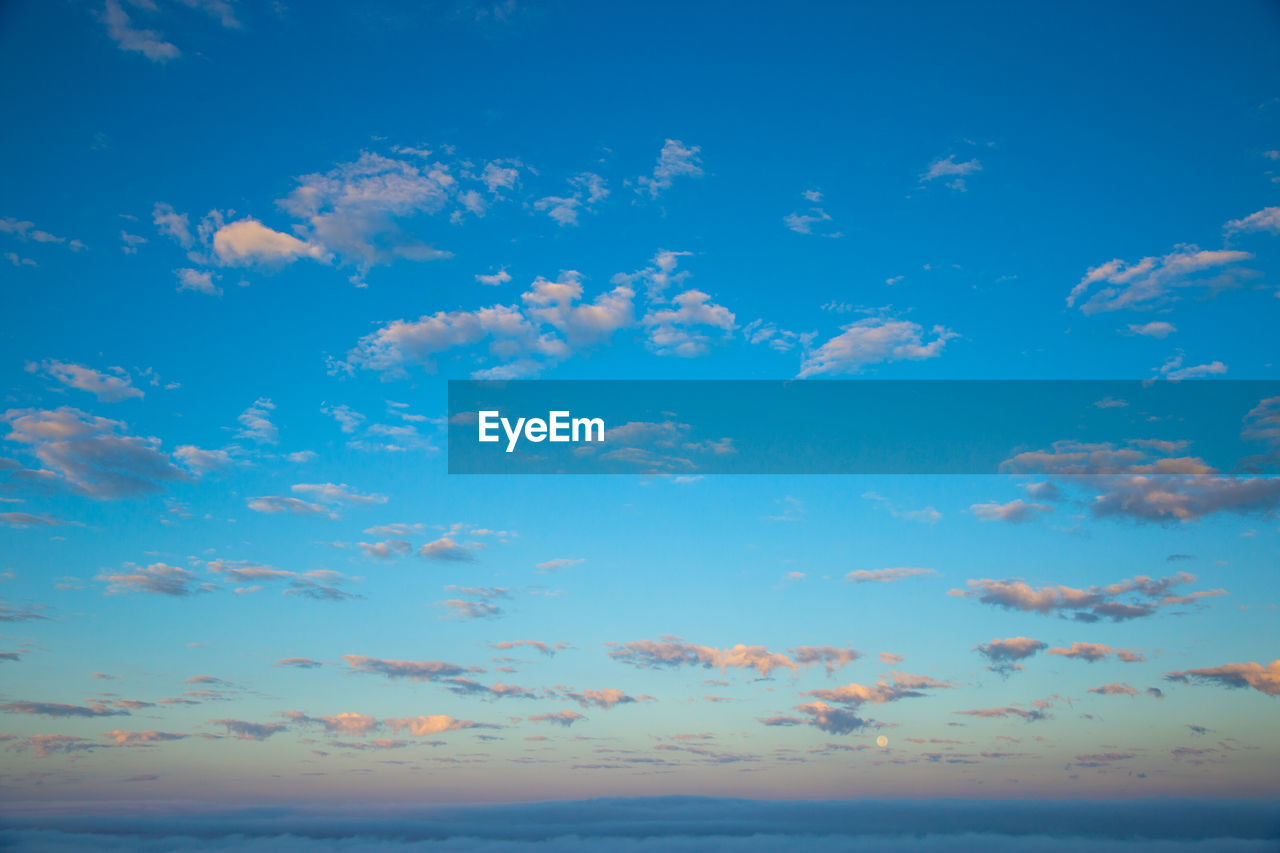 sky, cloud, blue, horizon, beauty in nature, scenics - nature, sea, nature, water, tranquility, horizon over water, tranquil scene, environment, ocean, no people, dusk, idyllic, sunset, outdoors, land, landscape, beach, sunlight, seascape, backgrounds, day, travel destinations, urban skyline