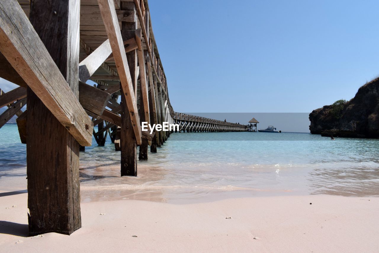 Pier over sea against clear sky