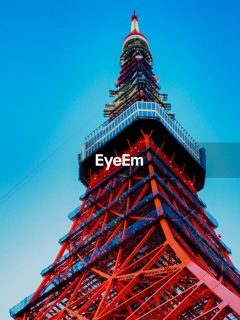 Low angle view of tokyo tower against clear blue sky