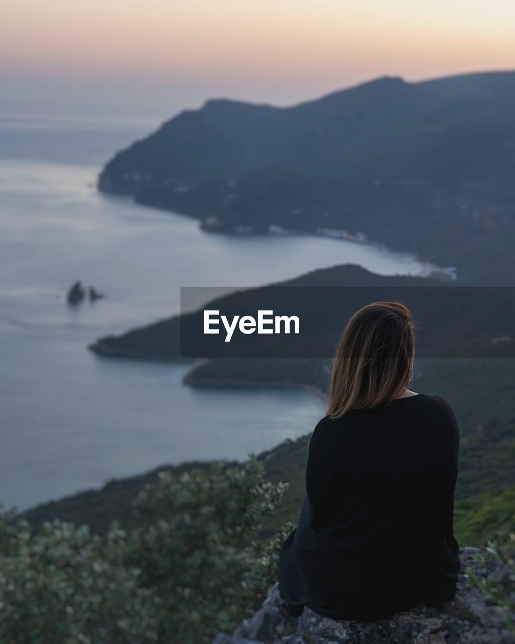 Rear view of woman looking at sea against sky