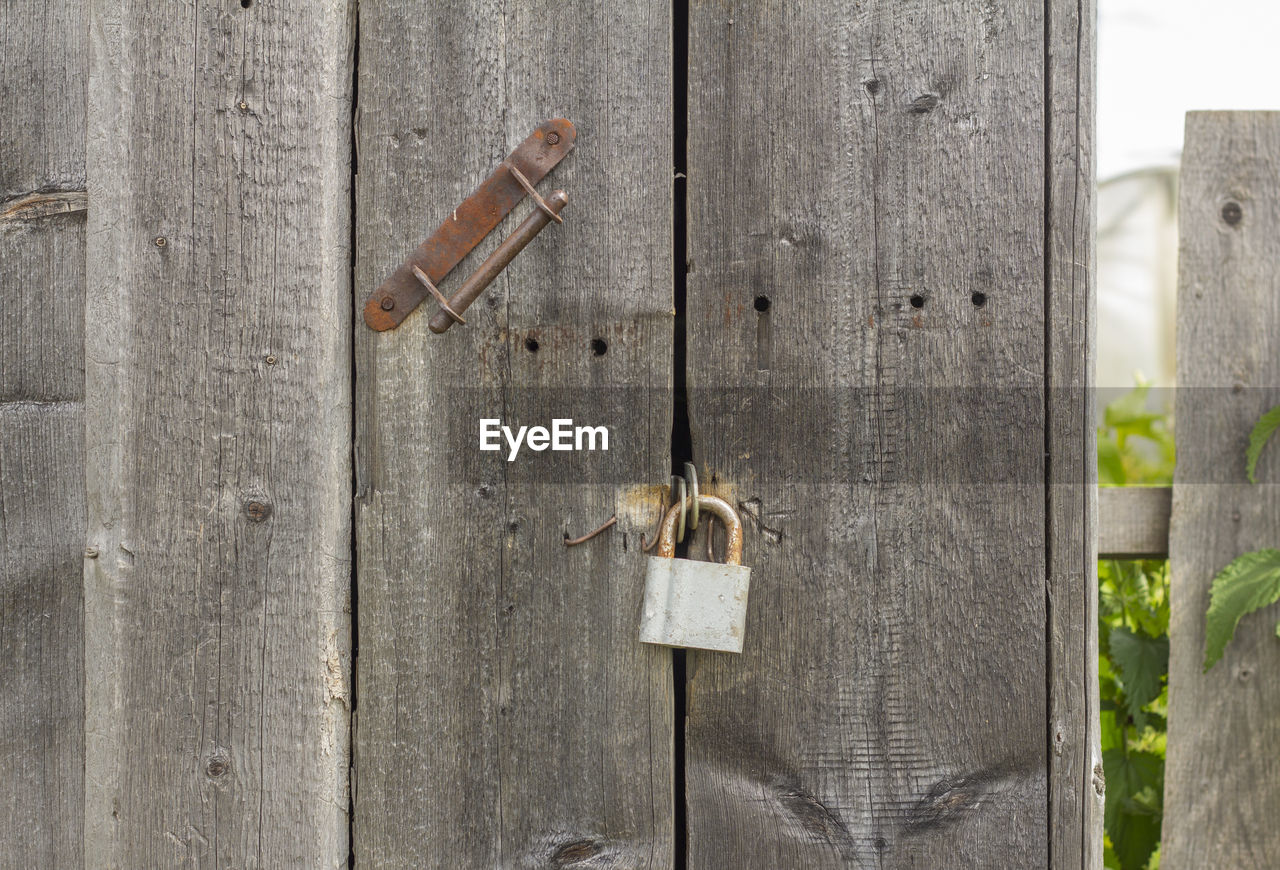 CLOSE-UP OF PADLOCKS ON FENCE