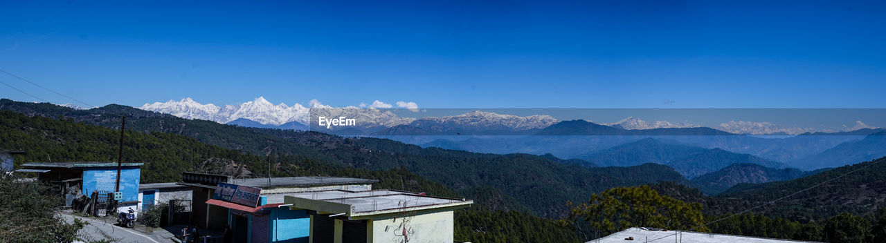 SCENIC VIEW OF MOUNTAINS AGAINST BLUE SKY