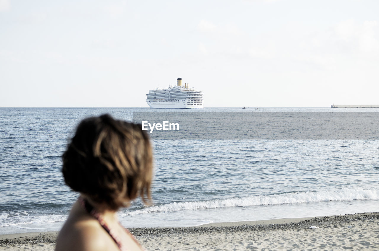 Rear view of woman looking at sea against sky