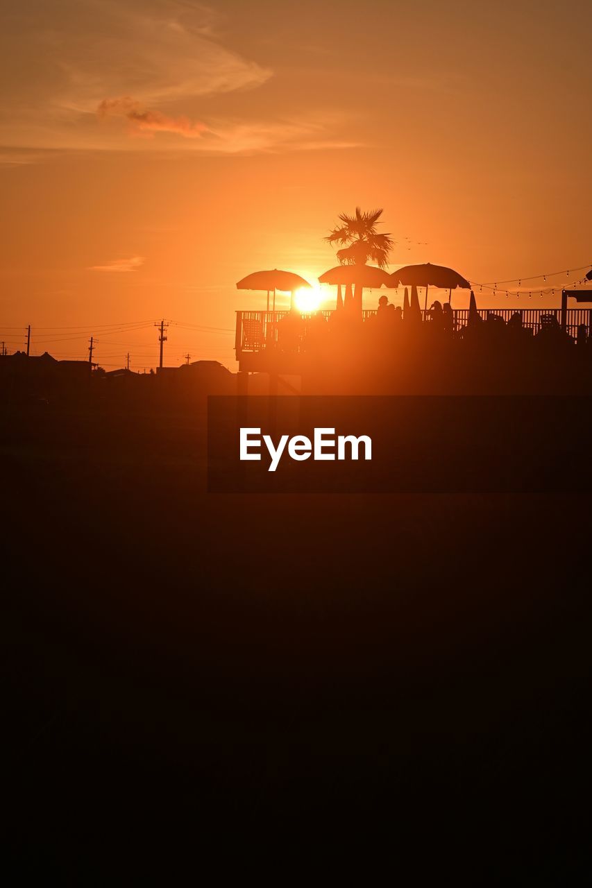 silhouette electricity pylon against sky during sunset