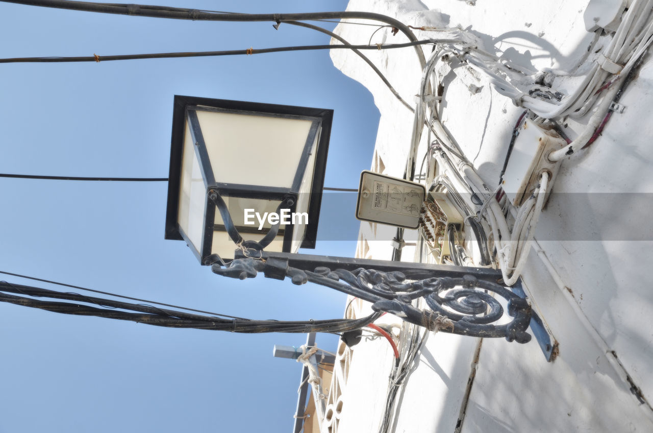 LOW ANGLE VIEW OF CABLES AGAINST CLEAR SKY