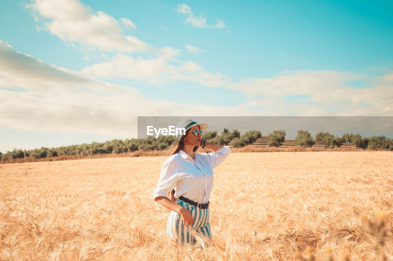 Woman standing on agricultural field