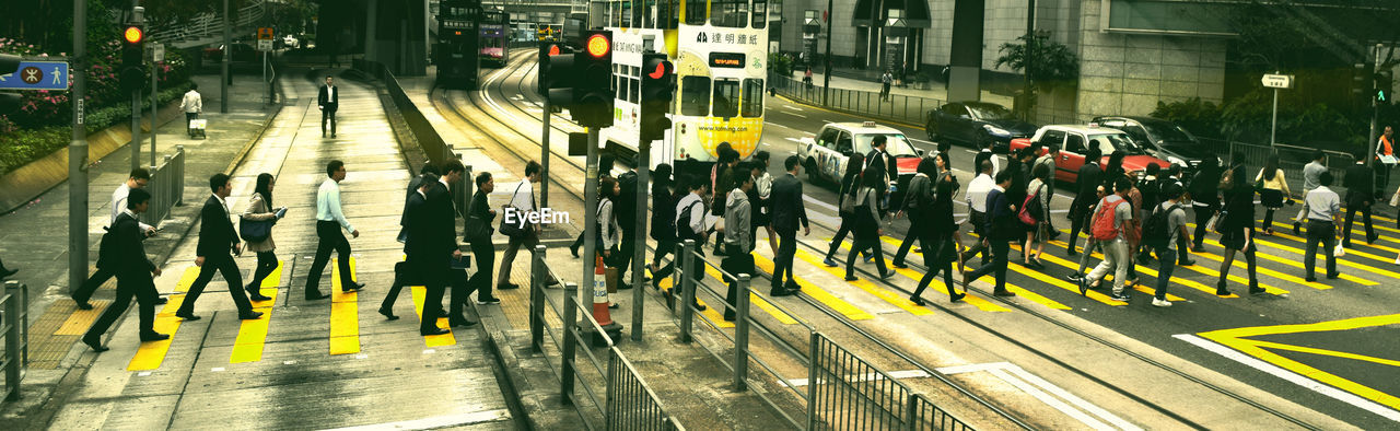 Side view of people crossing road