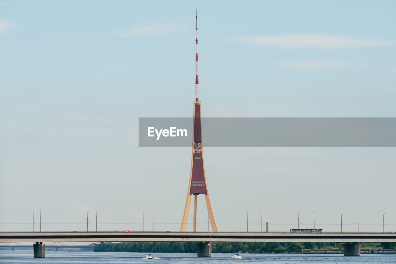 Suspension bridge over river against sky