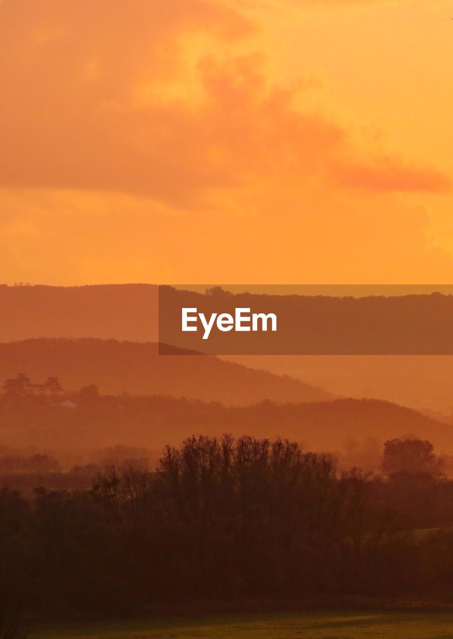 SCENIC VIEW OF MOUNTAINS AGAINST SKY DURING SUNSET