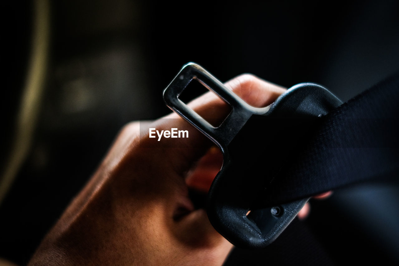 CLOSE-UP OF HUMAN HAND HOLDING EYEGLASSES