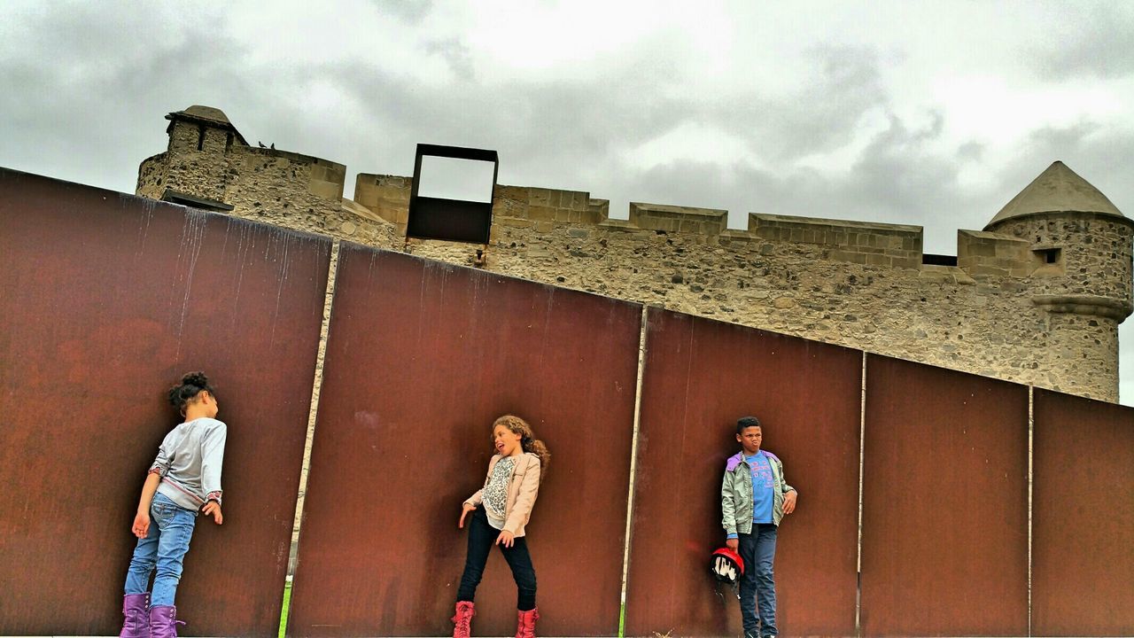 GROUP OF PEOPLE STANDING OUTSIDE BUILDING