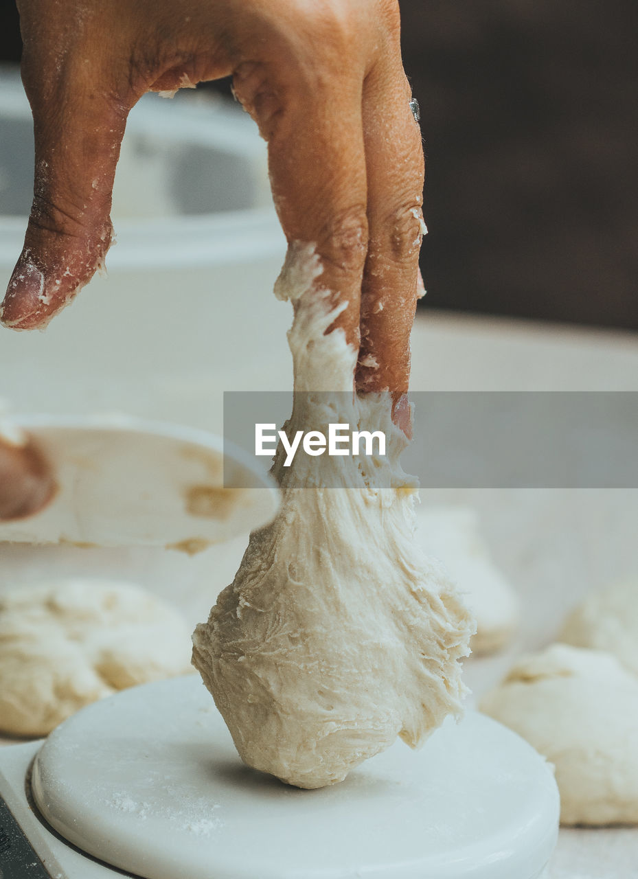 Cropped image of hand holding dough