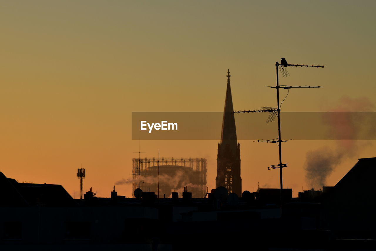 low angle view of silhouette buildings against sky during sunset