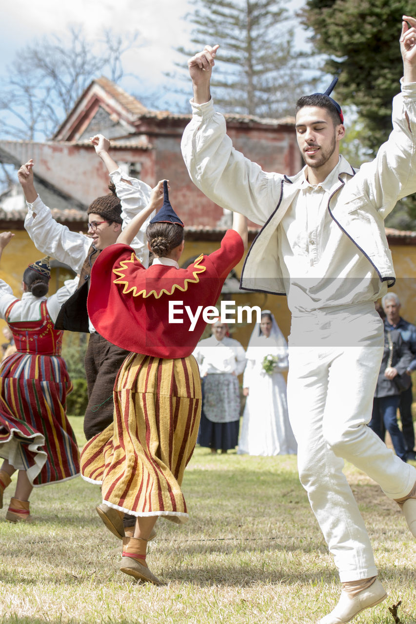 GROUP OF PEOPLE IN TRADITIONAL CLOTHING