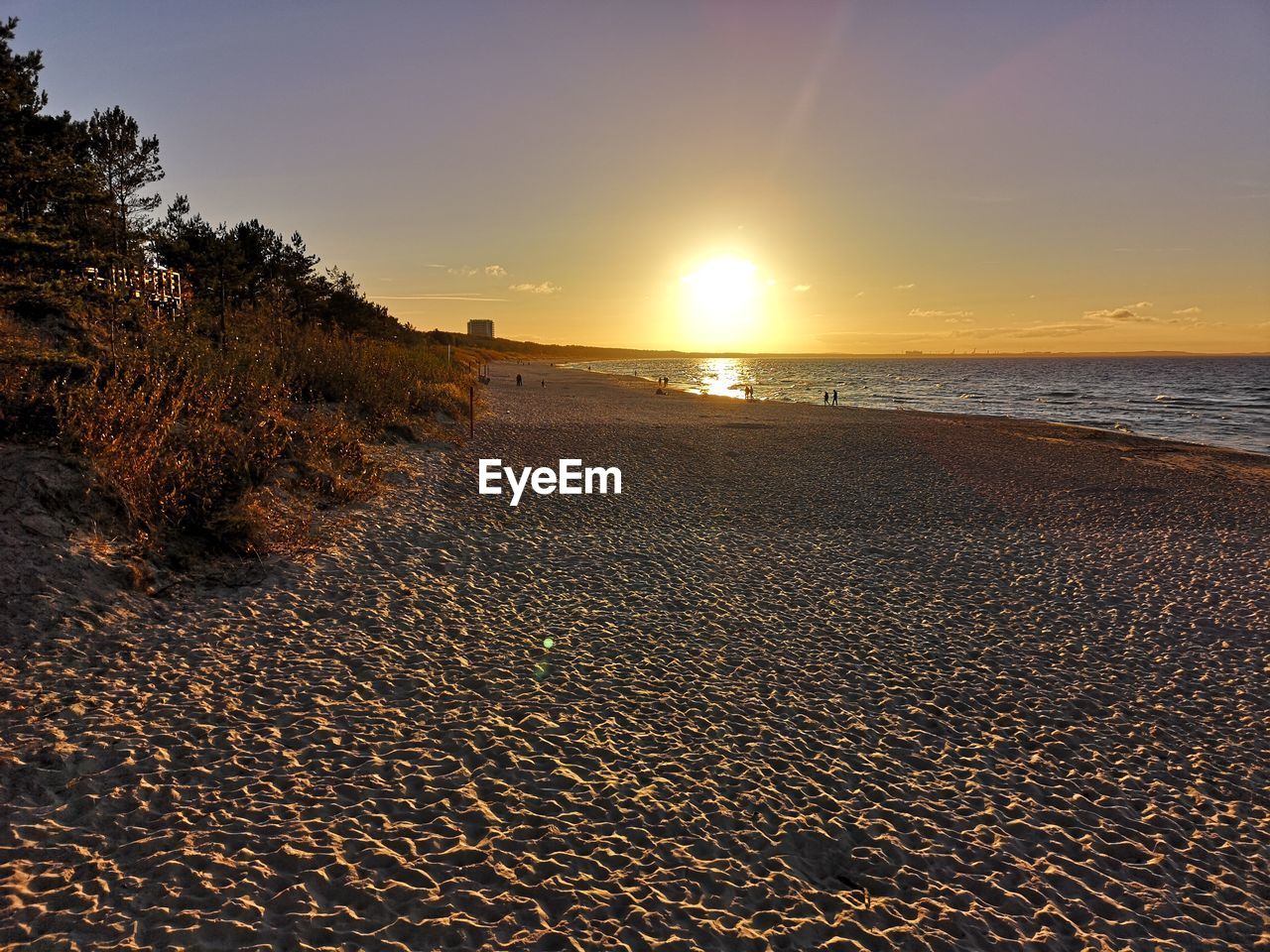 Scenic view of beach against sky during sunset