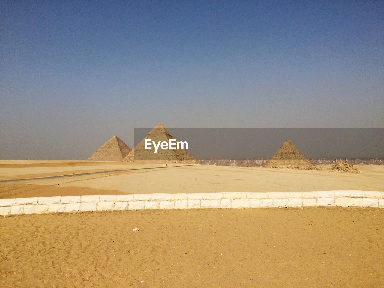 Distant view of great pyramid of giza against clear sky