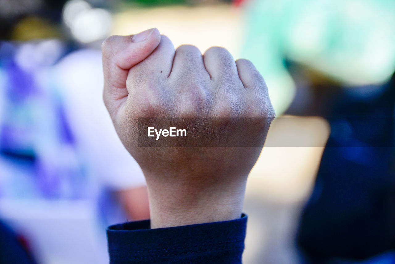 Close-up of hands against blurred background