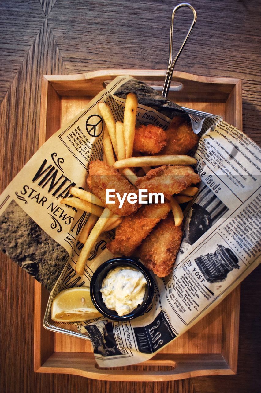 Directly above shot of fish and chips served on table