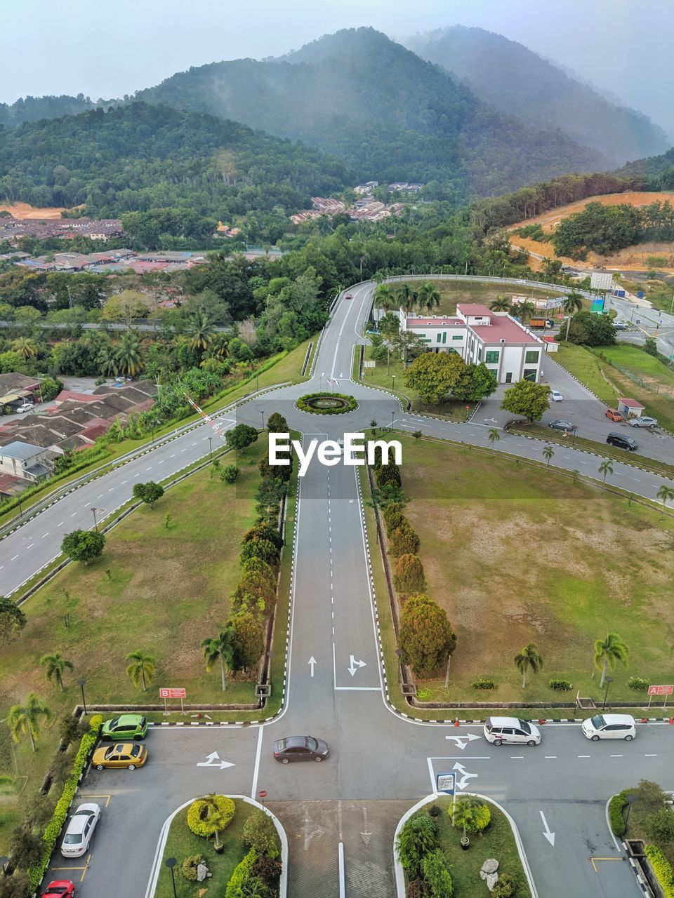 HIGH ANGLE VIEW OF STREET AMIDST TREES