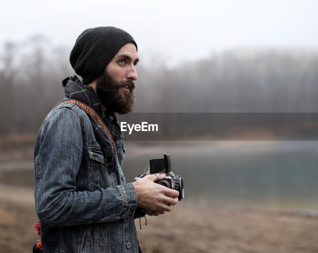 Portrait of young man with camera