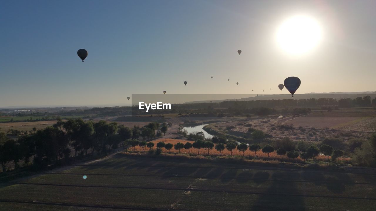 View of hot air balloon flying over landscape