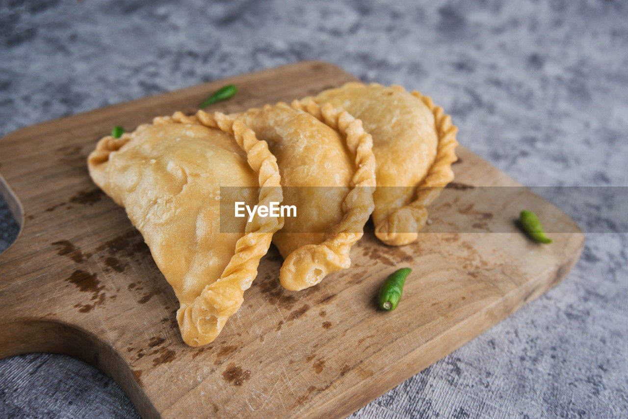 food and drink, food, freshness, cutting board, indoors, dish, wood, produce, healthy eating, table, no people, still life, high angle view, cuisine, close-up, wellbeing, snack, fast food, dessert, asian food, focus on foreground